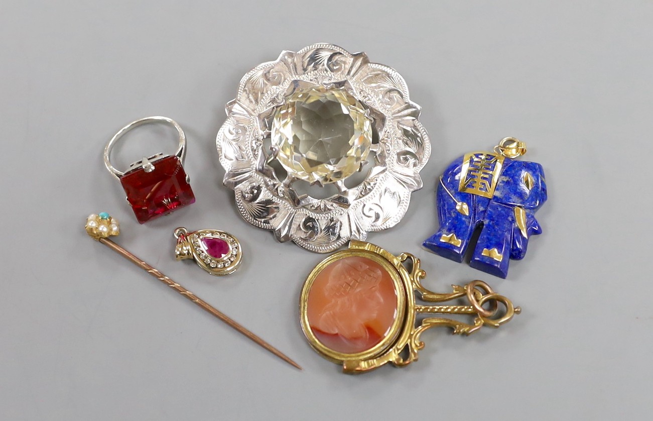 A modern yellow metal, ruby and diamond cluster set pear shaped pendant, overall 20mm, a Scottish silver mounted citrine brooch, a 9k mounted lapis lazuli elephant pendant, a 9ct dress ring, a gilt metal mounted and inta